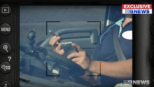 In one case, a male driver has a phone in each hand at the wheel and appears to be texting or actively using the touchscreen on one, while only the fingers of the other hand hang onto the wheel.