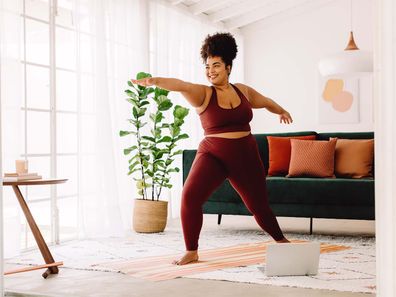 Woman working out in her home.