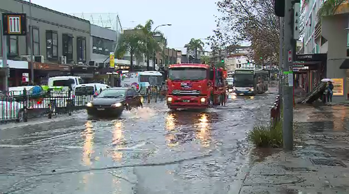 Neutral Bay traffic is slowed due to flooding through many streets.