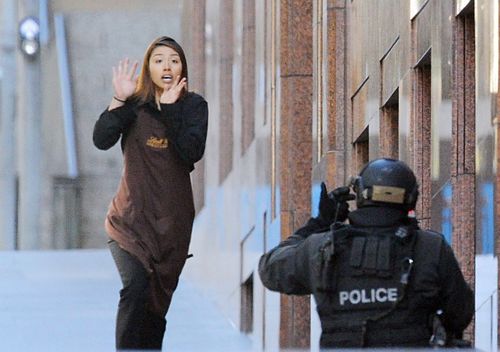 Sydney Siege hostage Elly Chen runs from the Lindt Cafe in Martin Place, Sydney, on December 15 2014.