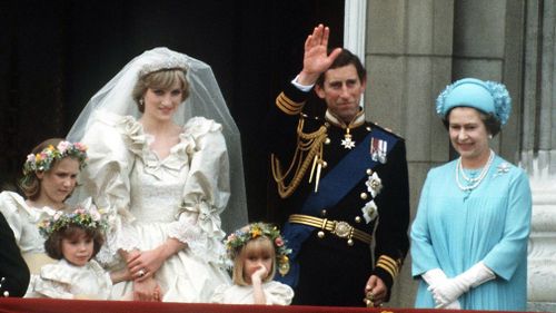 The Prince and Princess of Wales pose on the balcony of Buckingham Palace on their wedding day, with the Queen and some of the bridesmaids on July 29, 1981. (Getty)