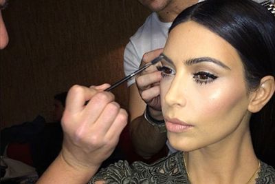 Unsurprisingly, Kim Kardashian was one of the first to post a shot of her mid make-up. But what we'd like to see is a before and after...especially when it takes two make-up artists to get her ready for the public.