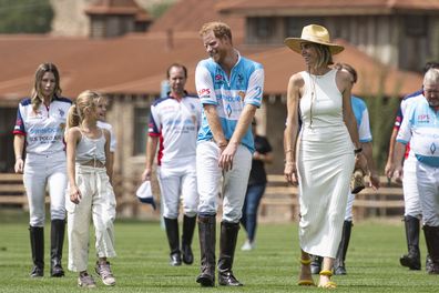 Prince Harry, centre, The Duke of Sussex, jokes with a young girl while walking to take part in the Sentebale ISPS Handa Polo Cup at Aspen Valley Polo Club Thursday, August 25, 2022, near Carbondale, Coloradoo