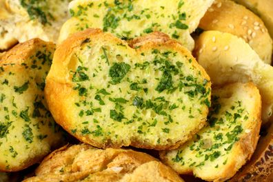 Delicious homemade herb and garlic crusty bread ready to serve.