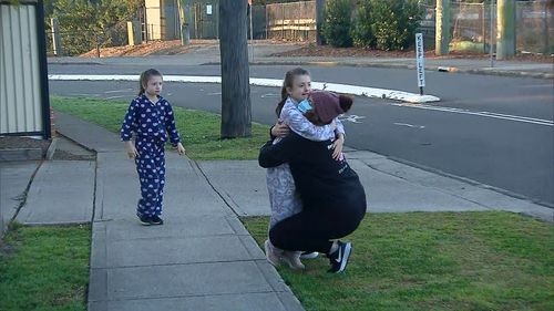Michelle being reunited with her twin daughters after she was locked down in her Blacktown apartment for two weeks.