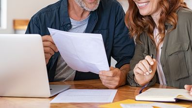 Couple looking at expenses on laptop