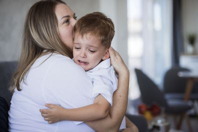 Mum comforting crying boy