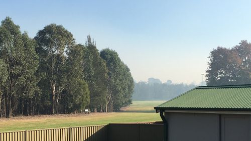 The smoke haze can be seen settled on the horizon at Lalor Park in Sydney's west. (Supplied: Rachel Spence)