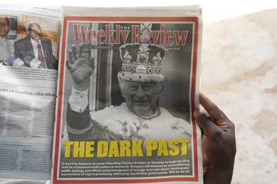 A Kenyan reads the Daily Nation newspaper with a portrait of Britain's King Charles III and the headline 'The Dark Past' in Nairobi, Sunday, Oct. 29, 2023.