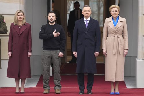 Poland's President Andrzej Duda, 2nd right, with his wife Agata Kornhauser-Duda welcomes Ukrainian President Volodymyr Zelenskyy with his wife Olena, left, as they meet at the Presidential Palace in Warsaw, Poland, Wednesday, April 5, 2023. 