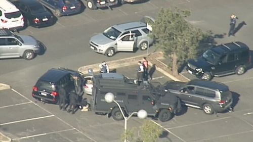 Heavily armed police surround vehicle in Melbourne's east after sleeping man spotted with firearm