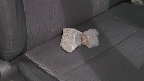 The fist-sized rocks landed inside Leanne's car. (9NEWS)