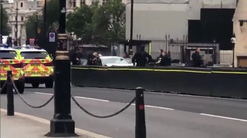 A man has been arrested after crashing into a security barrier outside the UK Houses of Parliament in London.