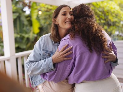 People exchange a welcome hug