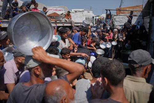 Palestinians line up to get donated food