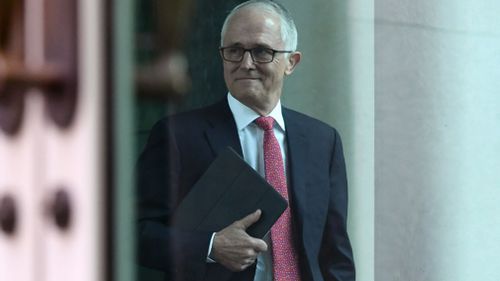 Malcolm Turnbull grins confidently as he enters the Liberal Party meeting ahead of a leadership vote.