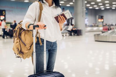 woman holding plane ticket