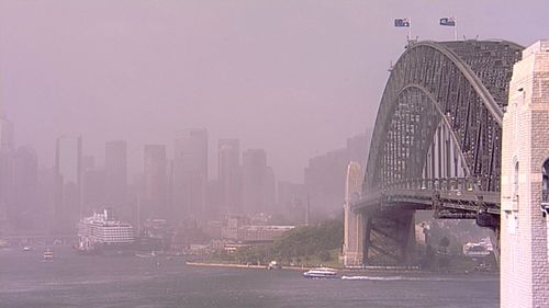 The dust obscures Sydney's CBD as it passes over the Harbour Bridge.