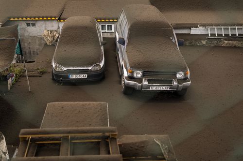 Vehicles are covered by ashes from a volcano eruption in La Palma