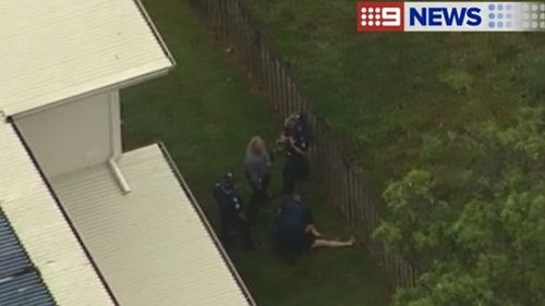 Police arrest a man at Coomera Waters following an extensive search through the area. (9NEWS)