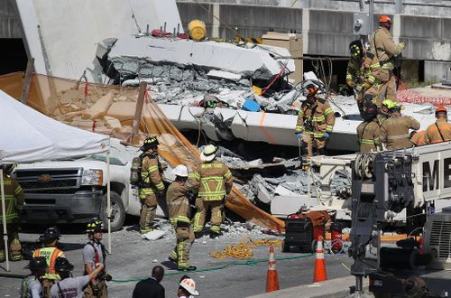 Emergency crews are working to rescue people trapped beneath the collapsed bridge. (Getty)