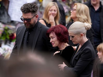 BIRMINGHAM, ENGLAND - JULY 30: Jack Osbourne, Sharon Osbourne, Kelly Osbourne and family members stop to view tributes to the late Ozzy Osbourne from fans at Black Sabbath Bench and Bridge as his funeral cortege travels through his home city of Birmingham on July 30, 2025 in Birmingham, England. The Black Sabbath frontman passed away on July 22nd at the age of 76. His death occurred just a little over two weeks after his final live performance at the 'Back to the Beginning' concert in his hometo