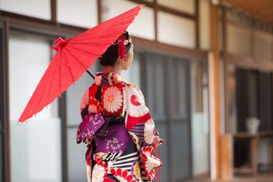 A young woman in traditional Kimono admiring the magnificent architecture of Hyakumanben Chionji Temple in Kyoto, Japan