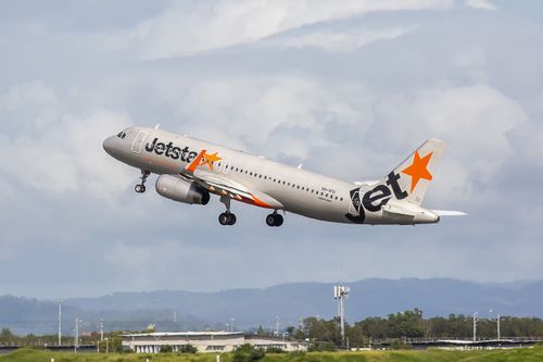 This image is of a Jetstar Airbus A320 departing Brisbane International Airport runway 19L. Jetstar Airways Pty Ltd, operating as Jetstar, is an Australian low-cost airline (self-described as "value-based") headquartered in Melbourne. It is a wholly owned subsidiary of Qantas, created in response to the threat posed by airline Virgin Blue. Jetstar is part of Qantas' two brand strategy of having Qantas Airways for the premium full-service market and Jetstar for the low-cost market. Jetstar carrie