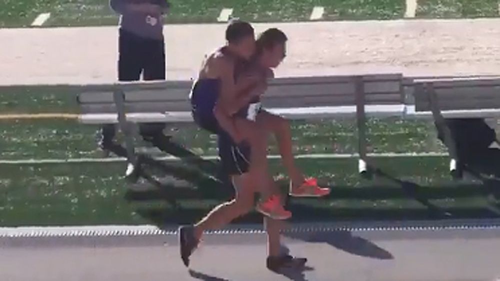 High school athlete carries injured teammate over the finish line