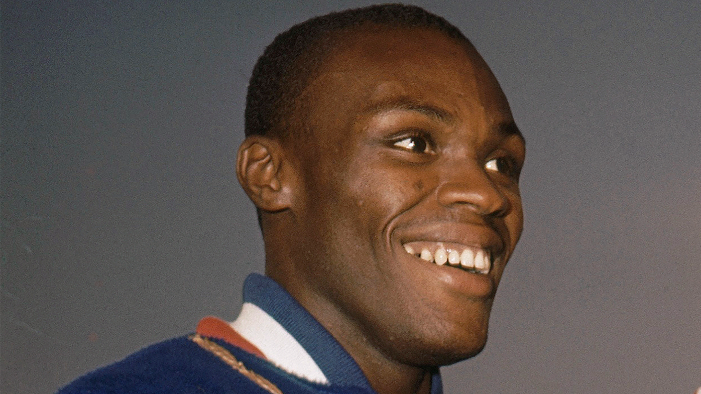 Ralph Boston smiles on the podium at the 1960 Summer Olympics in Rome.