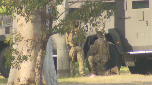 A tactic vehicle wheeled into the suburb amid reports of an armed man. 