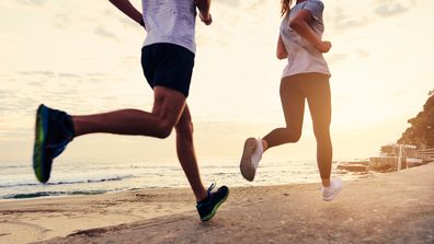 People running exercise couple beach jogging