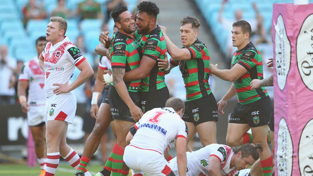 John Sutton celebrates with teammates after scoring for souths.(Getty)