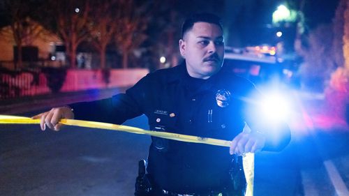 A police officer blocks off a street near Rob Reiner's residence Sunday, Dec. 14, 2025, in the Brentwood section of Los Angeles. (AP Photo/Ethan Swope)