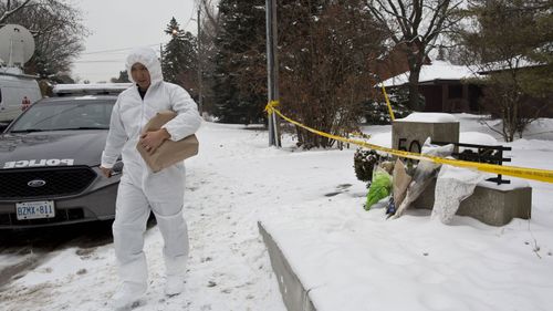 An investigator leaves the Sherman house in December. Photo: Getty Images