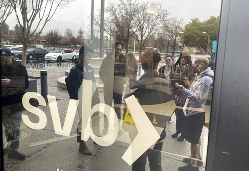 People line up outside of the shuttered Silicon Valley Bank (SVB) headquarters on March 10, 2023 in Santa Clara, California. 