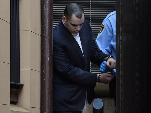 Matthew Flame in handcuffs is led out of the King Street Court building into a prison van on October 23.