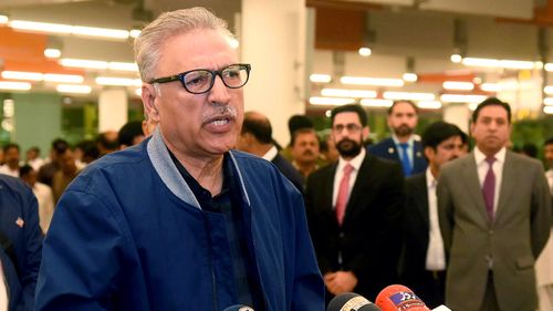 Pakistan's President Arif Alvi speaks to journalists prior to departing to Turkey, in Islamabad.