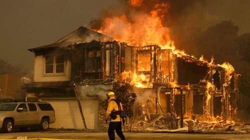 Wildfires whipped by powerful winds swept through Northern California sending residents on a headlong flight to safety through smoke and flames as homes burned. (AP)