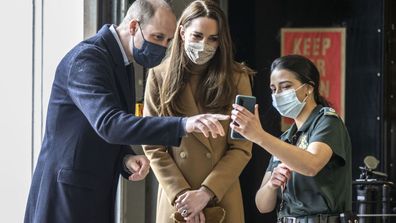 Britain's Prince William and Kate, Duchess of Cambridge talk with the family of paramedic Jahrin (Jay) Khan via a mobile phone, during a visit to Newham ambulance station, in East London, Thursday March 18, 2021.