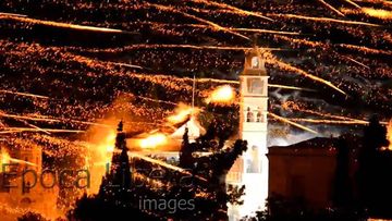 A stunning display... rockets explode on the bell tower of a Greek church. Click through to watch the video. 