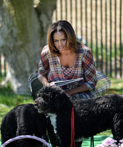 Michelle Obama with her dogs looks on during the annual White House Easter Egg Roll in 2014.
