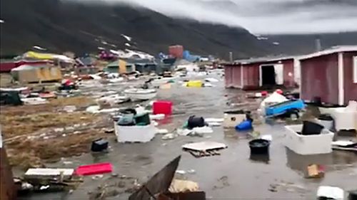 Grab taken from a video shows houses close to Nuugaatsiag, Greenland, flooded by tidal waves on June 18, 2017. (AFP)