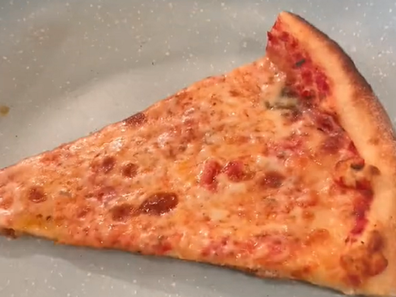 Reheating pizza using stove top