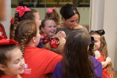 Ms Markle is swamped by her young adoring fans during a visit to Star Hub in Tremfora. (AAP)