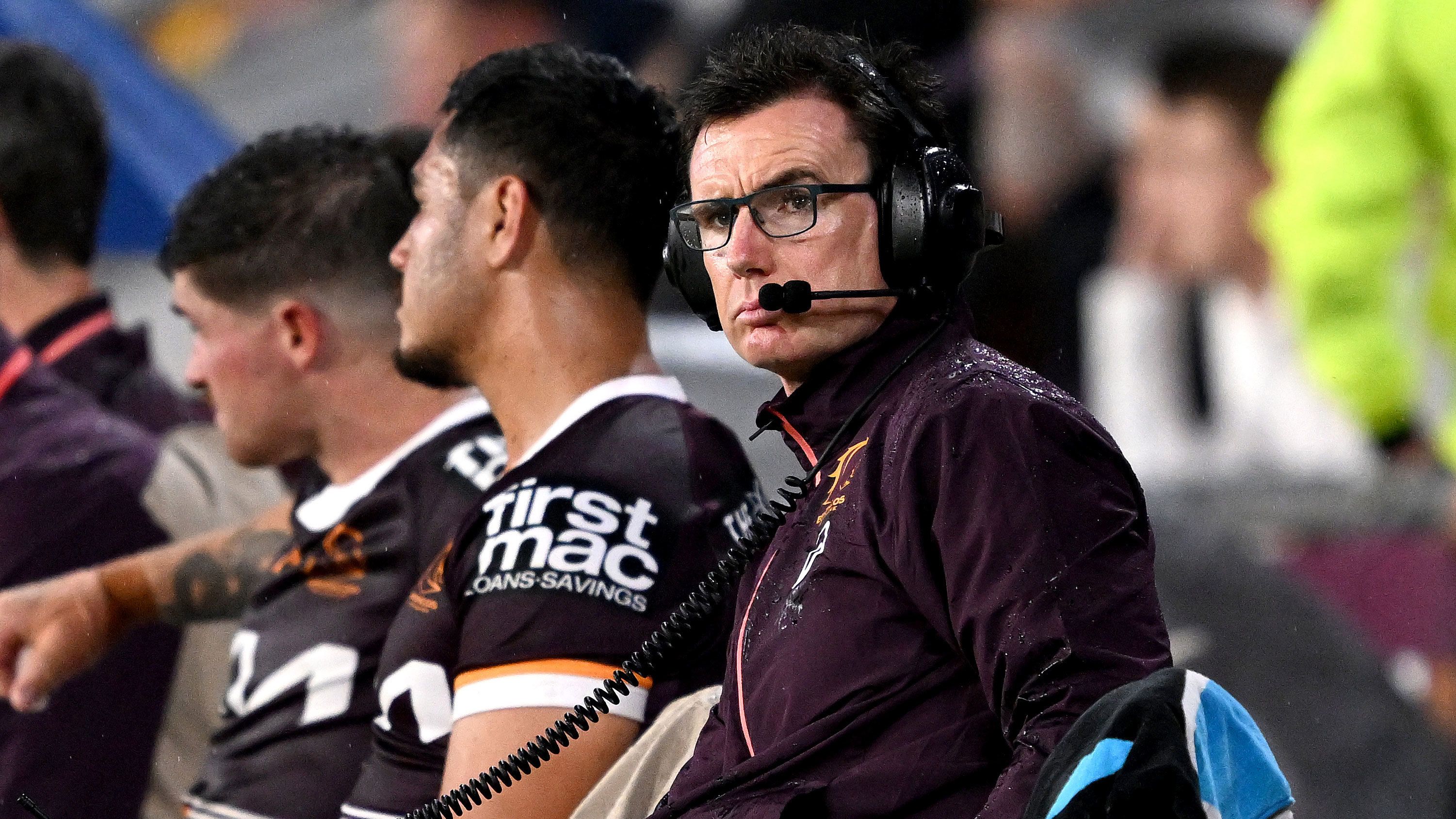 Then Broncos head of football Ben Ikin works from the bench during their round two clash with the Cowboys at Suncorp Stadium on March 10, 2023.