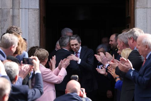 The new Prime Minister of Ireland Simon Harris, at centre, is applauded by fellow lawmakers outside Leinster House in Dublin, Ireland, Tuesday, April 9, 2024.