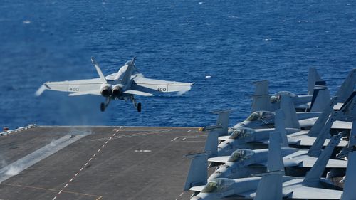 F/A-18E Super Hornet from VFA 25 launches from the flight deck of the Nimitz-class aircraft carrier USS Abraham Lincoln. 