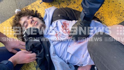 Mert Ney is held down and searched by police following a stabbing rampage in Sydney's CBD.