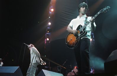 Oasis play in concert in Melbourne on March 1, 1998